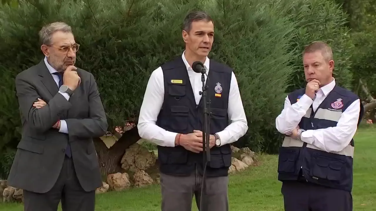 Pedro Sánchez, con chaleco de Protección Civil, habla ante un micrófono junto a Emiliano García-Page, tras la reunión del CECOPI por el accidente de Urda.